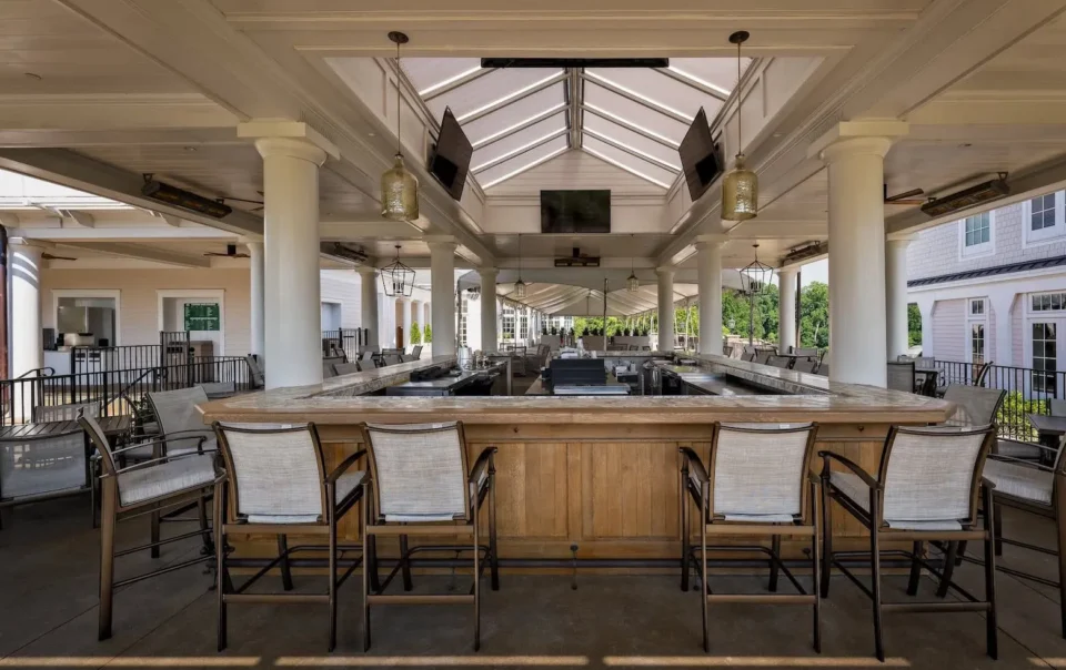 Outdoor covered bar at Druid Hills Golf Club featuring integrated AV displays, speakers, and lighting solutions installed by Macrotek Services.